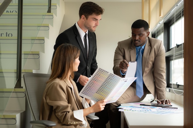 Business people analyzing impact charts of the tax reform on different industries.