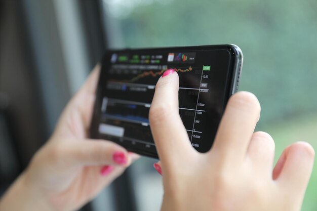 A close-up of a smartphone screen displaying a real-time transaction monitoring dashboard, with highlighted suspicious activities and alerts, showing features like unusual transaction amounts, locations, and frequencies.