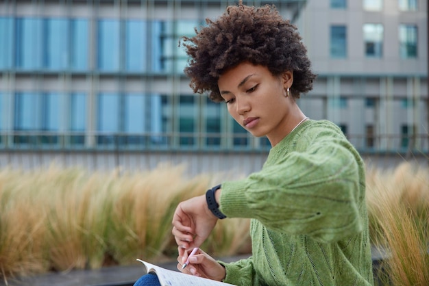 A person using a smartwatch to quickly check their daily agenda while walking to work, showcasing the convenience of having organizational tools readily available on a wearable device.