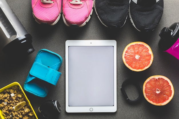 A collage showcasing various fitness apps interfaces on different mobile devices (smartphones and tablets).