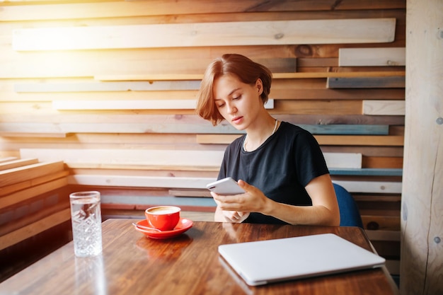 A person studying languages with a language learning app on a tablet in a cozy cafe, with a cup of coffee. The light is soft and inviting, suggesting a moment of relaxed learning.