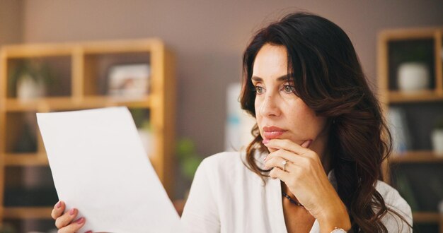 A concerned person reading a legal document. The document is a BPC eligibility sheet.