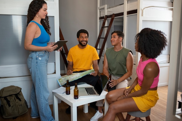A photo showcasing a diverse group of people attending a Minha Casa Minha Vida information session. The attendees are listening attentively, with brochures and informational materials visible on the tables.
