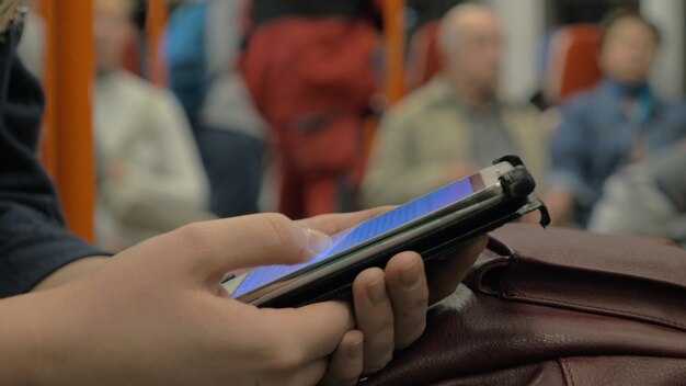 Close-up of a smartphone displaying a digital ID Jovem card, with icons of events and transportation options around it. The image should be well-lit and focus on the card details.