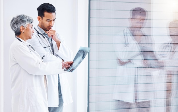 A doctor in a white coat examining an x-ray of a spine, highlighting the vertebrae and potential issues that could lead to disability and the need for disability retirement benefits.