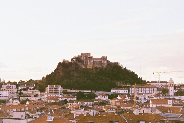 A panoramic view of Ouro Preto, Minas Gerais, showcasing the historical architecture with colonial buildings and churches against a backdrop of rolling hills, bathed in the warm light of the late afternoon, capturing the city's unique charm.