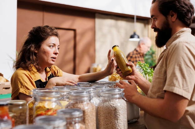 A diverse group of people shopping at a zero-waste grocery store, filling reusable containers with bulk grains, nuts, and other products. The image emphasizes sustainability and conscious consumption.