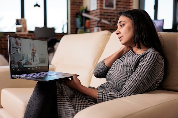 A person using a laptop to connect with a therapist during an online session, highlighting the use of technology for mental health support.