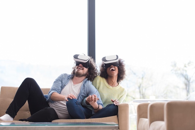 A group of people wearing VR headsets in a living room, experiencing immersive entertainment powered by 5G connectivity, with fast data transfer and low latency enabling seamless virtual reality experiences.